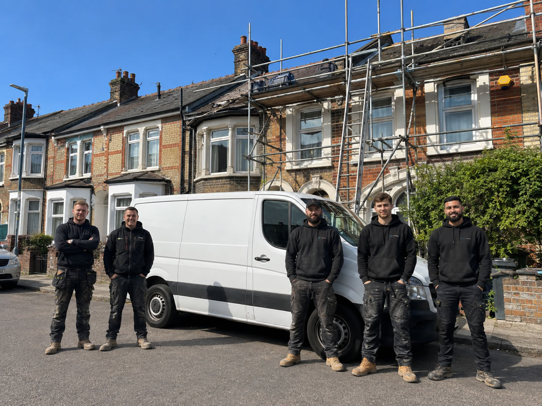 UK roofers with a white van at a roofing job